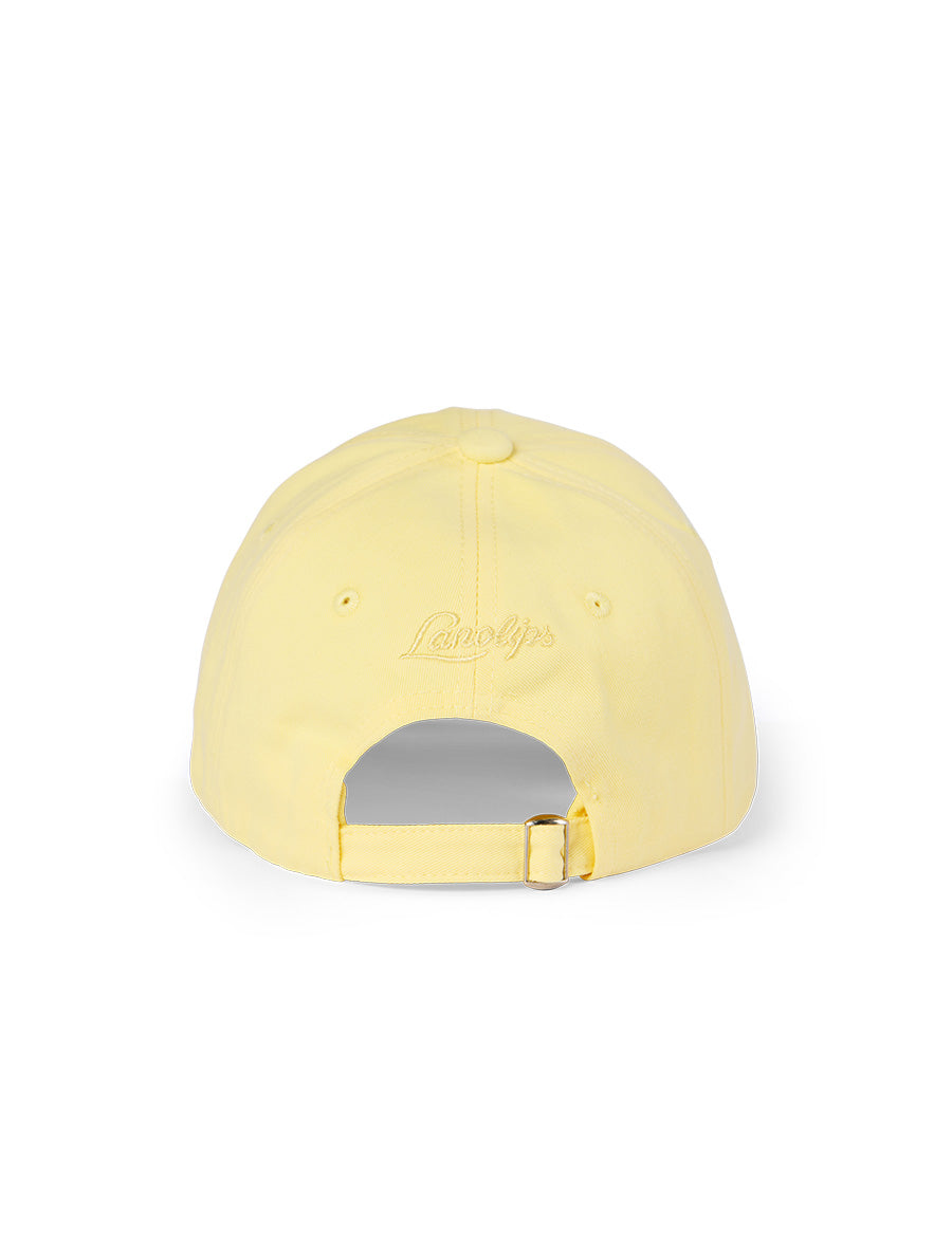 Lanolips Go Bananas Yellow Cap showcases a back view with an adjustable slider fastening, allowing you to easily customize the fit for most head sizes. The cap also features the iconic Lanolips logo on the back, adding a touch of brand flair to your style.
