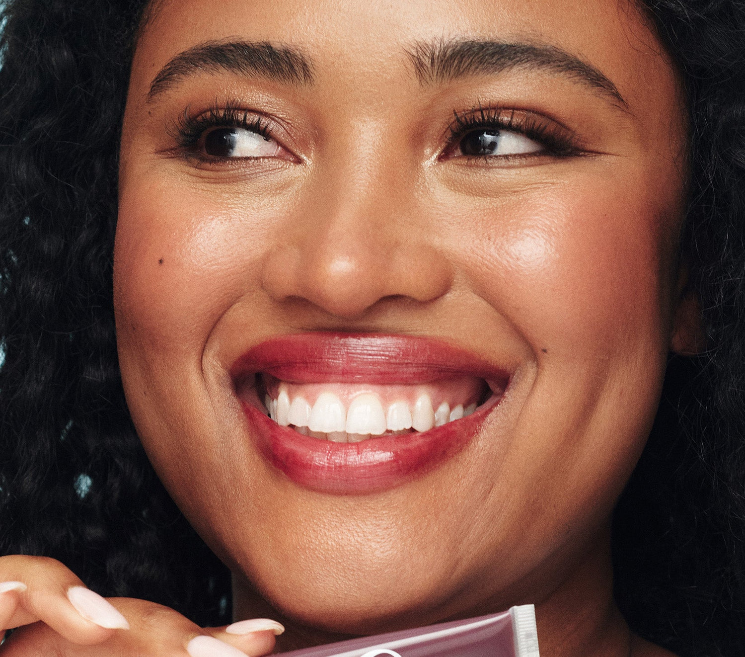 Model wearing the Lanolips Tinted Lip Balm in Spice on her lips - a lanolin rich lip moisturiser. Spice, a rich plum shade inspired by the 90s, delivers a wine-stained look with deep hydration instead of the hangover. Designed in Australia, and made in the UK with Australian and New Zealand lanolin, this 98.8% natural formula is packed lanolin, vitamin e and shea butter. With just 1% tint, this ultra wearable balm enhances the lips' natural beauty - so good, you'll want to throw away your lipstick.