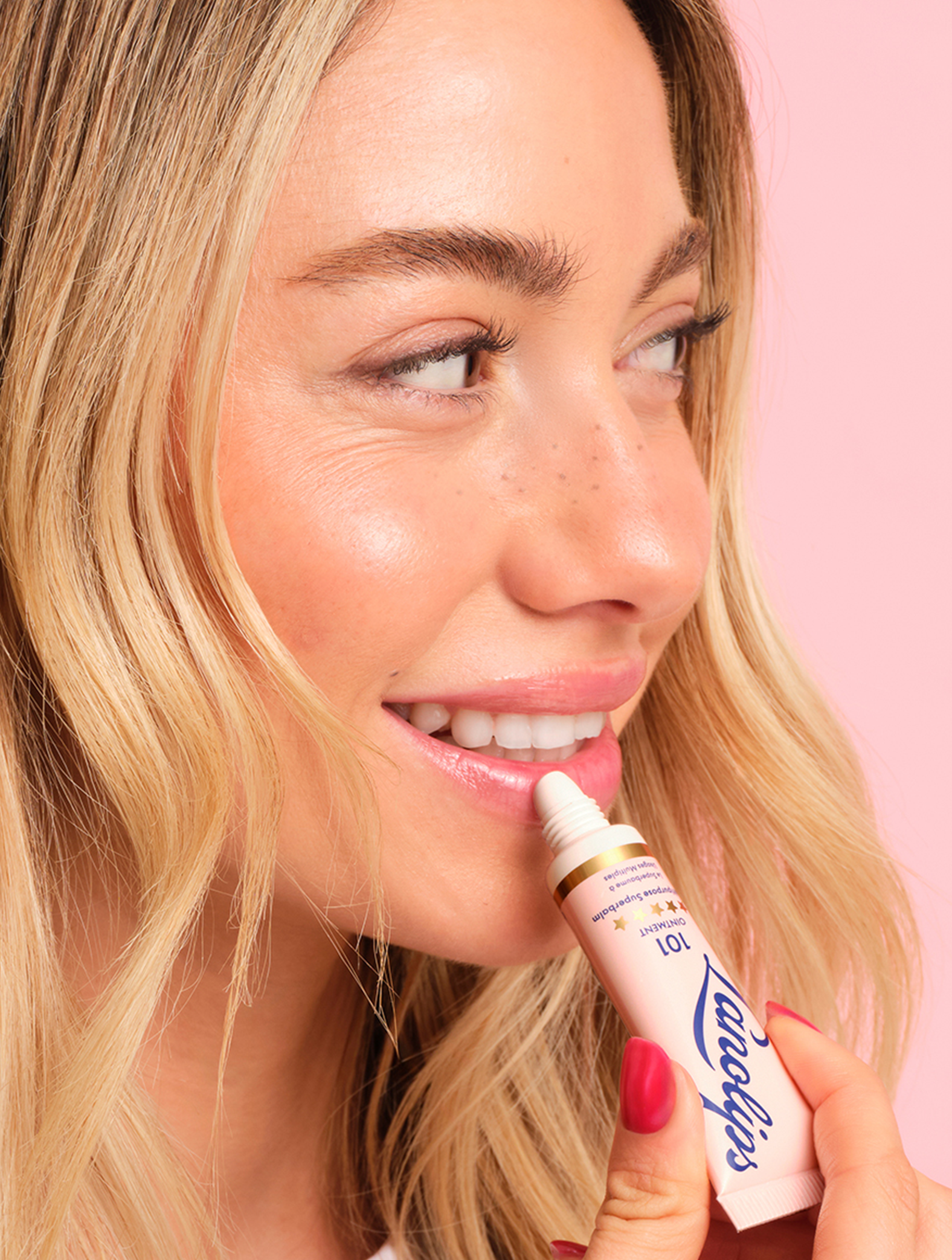 Close up a model applying their lips with a tube of Lanolips The Original 101 Ointment Multipurpose Superbalm close to her face. This 100% natural, multi-award-winning balm is a powerful multi-tasker with 101 use - from ultra-hydrating lips to soothing dry skin. Voted ‘The World’s Best Lip Balm,’ it’s a hard-working formula designed to deeply nourish and lock in moisture. Made with 100% ultra-pure grade lanolin, it mimics the skin’s natural oils, leaving lips soft, smooth and glossy.