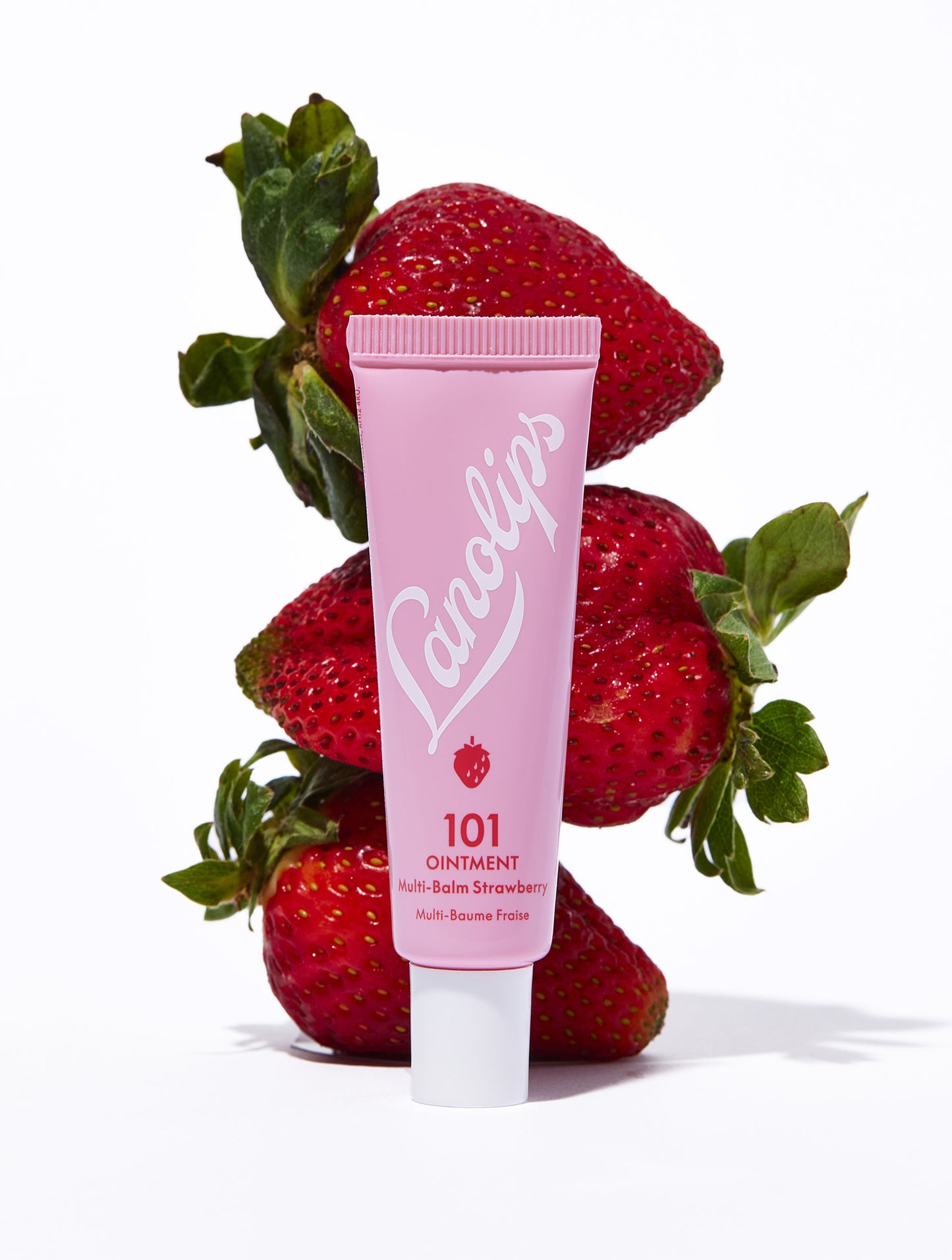Lanolips 101 ointment strawberry tube with fresh strawberry fruits.