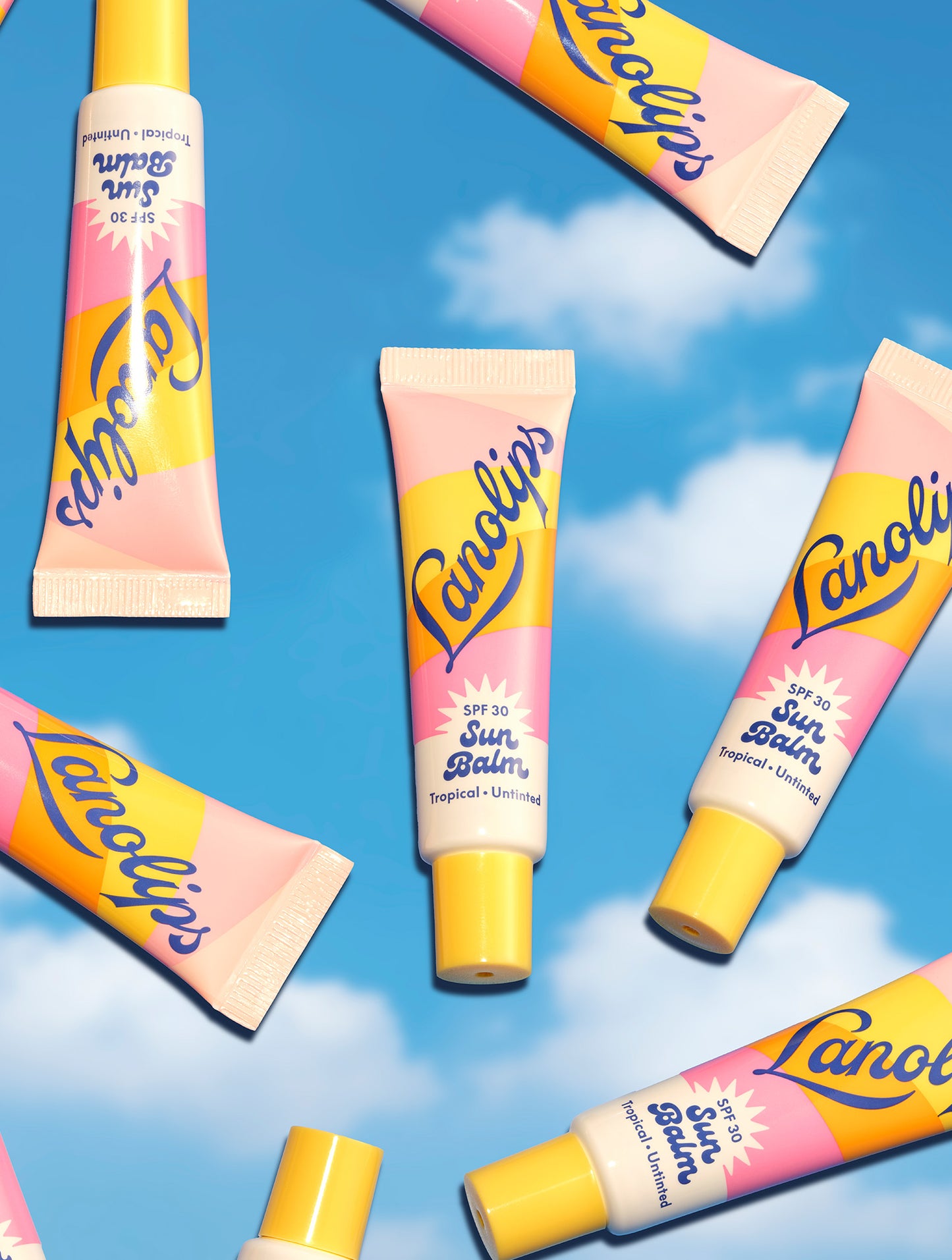 Multiple tubes of Lanolips Sun Balm SPF 30 Tropical float on a sky background - glossy, untinted, SPF-packed hydration for all-day, all-year sun protection.