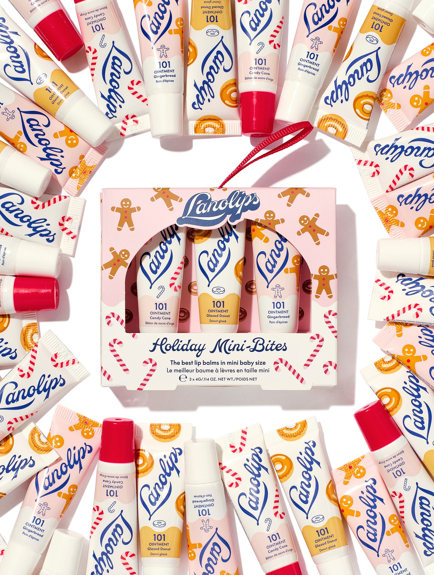 Lanolips Holiday Mini Bites lip balm gift set surrounded by tubes in Candy Cane, Gingerbread and Glazed Donut flavours, packed with rich lanolin, vitamin E and natural flavors, a holiday festive twist.