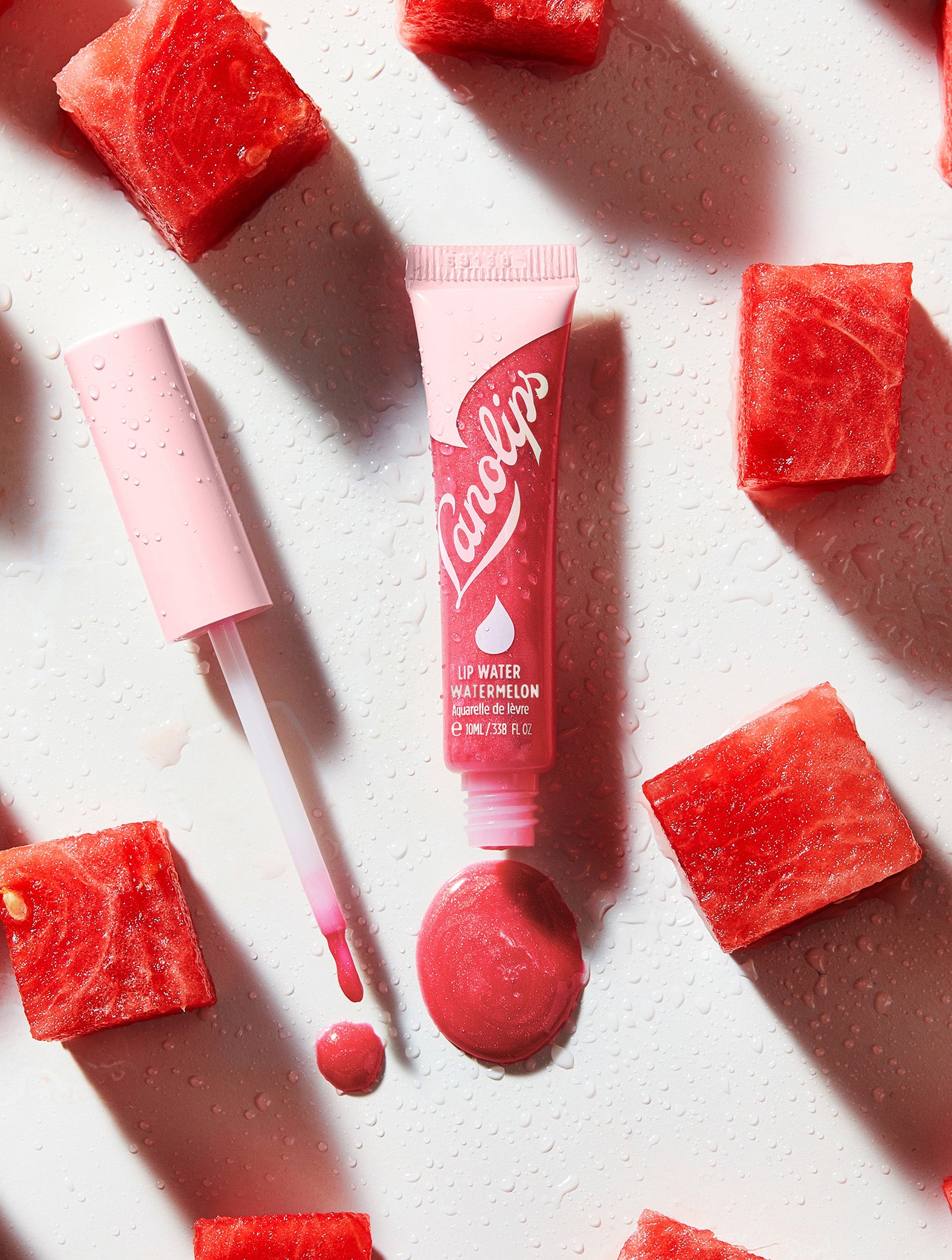 Lanolips Lip Water Watermelon is a transparent watermelon-pink holographic shimmer - for watermelon juice-tasting lips that are both hydrated and glowing.