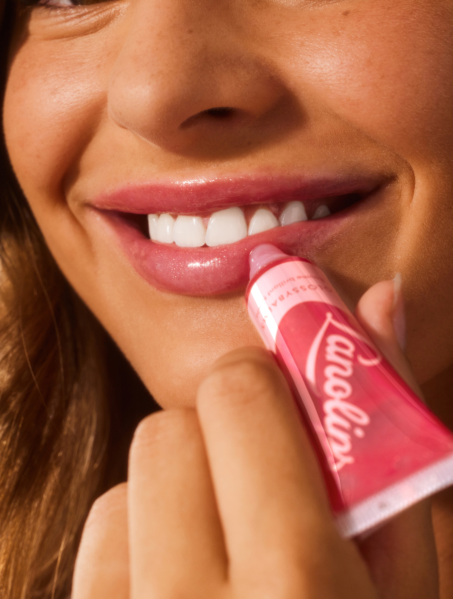 Model applying Lanolips' Glossy Balm Candy
