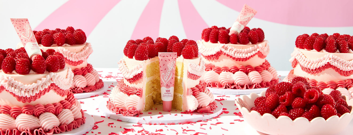 Lanolips 101 delicious raspberry tube sitting in a raspberry shortcake cake depicting the flavor of the lip balm.