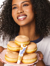 Lanolips 101 Delicious Duo | Load image into Gallery viewer, Model holding the Lanolips 101 Ointment Glazed Donut
