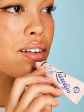 The Original 101 Ointment Duo | Load image into Gallery viewer, Close up shot of a model applying the Lanolips Original 101 Ointment on her lips. Made with 100% ultra pure grade Aussie lanolin, the Original 101 Ointment provides intense moisture, perfect for dry and chapped lips.

