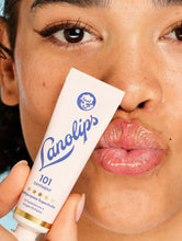 The Original 101 Ointment Duo | Load image into Gallery viewer, Model holding a tube of the Lanolips Original 101 Ointment - 15g. Voted the &quot;World&#39;s Best Lip Balm&quot;. Using ultra-pure grade Aussie lanolin, our cult classic 101 Ointment offers a safer, more effective &amp; 100% natural alternative to common petroleum-based balms.

