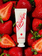 Squeezed tube shot of the Lanolips Lip Scrub Strawberry. A 100% natural balm based scrub that smooth and hydrates. | Load image into Gallery viewer, Lanolips Lip Scrub Strawberry is a 100% natural balm based scrub, containing ingredients including our ultra-pure grade lanolin, real finely ground strawberry seeds and sugar.
