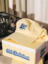 Lanolips Classic Drip Yellow Cap front view. Made with 100% cotton, and the Classic Drip embroidered slogan at the front.  | Load image into Gallery viewer, Lifestyle shot of the Lanolips Classic Drip baseball style cap.
