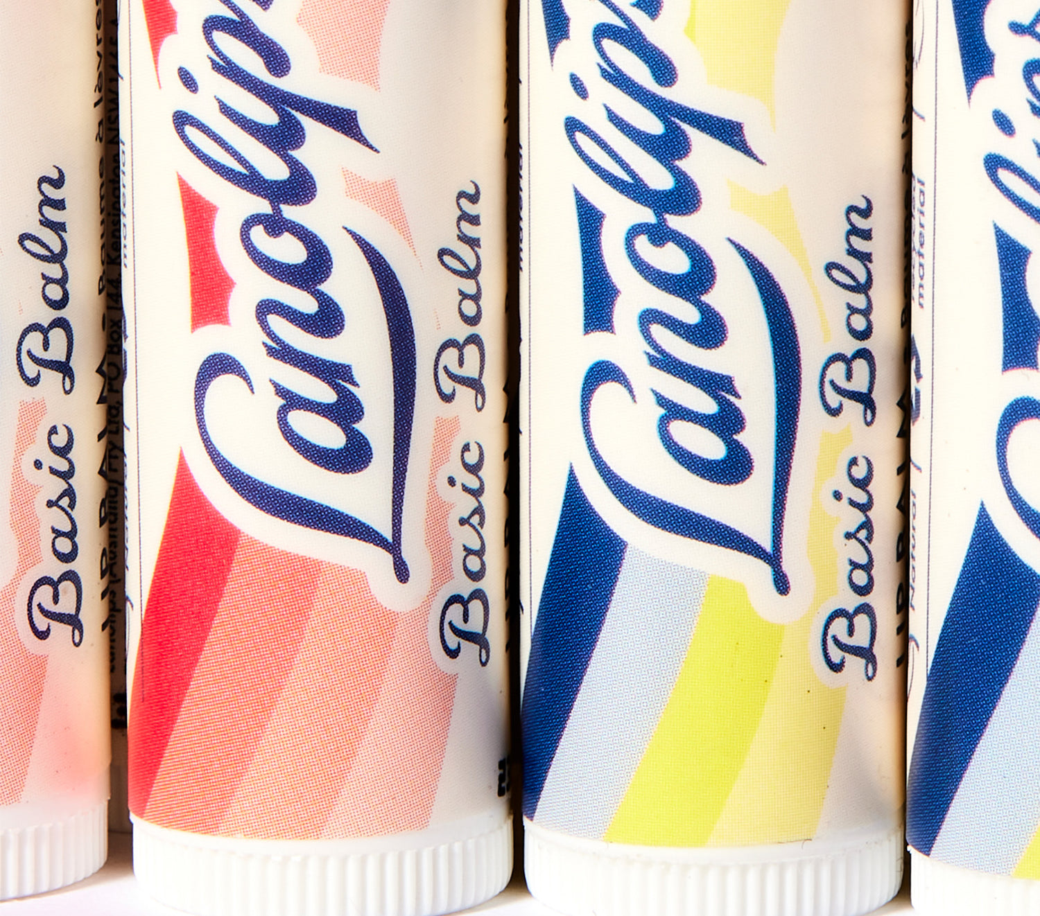 Lanolips Basic Balm tubes in various colors with visible branding.