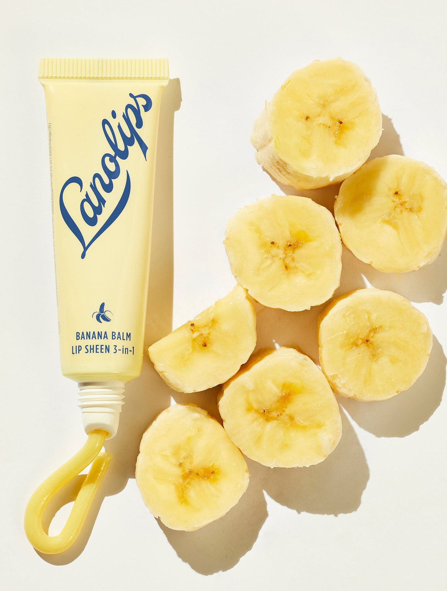 Lanolips Banana Balm Lip Sheen 3-in-1 tube squeezed with banana pieces.