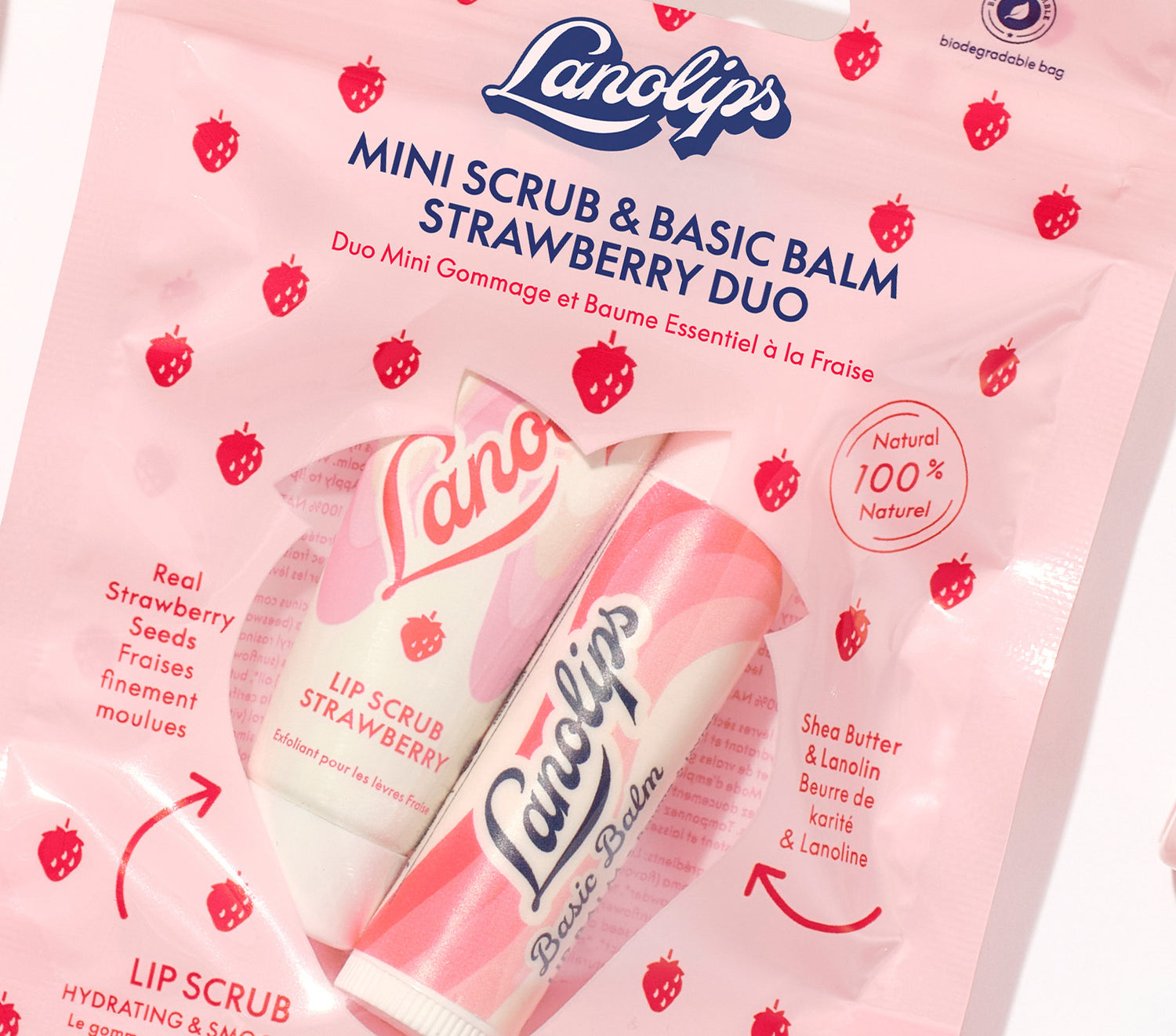 Lifestyle shot of the Lanolips Mini Scrub & Balm Duo in Strawberry. Contains our bestselling 101 Ointment Multi Balm Strawberry and Lip Scrub Strawberry. 