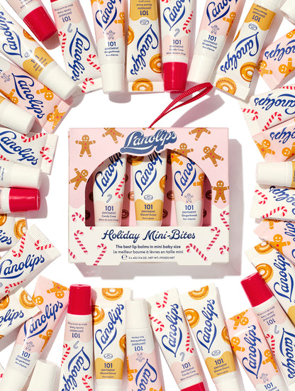 Lanolips Holiday Mini Bites lip balm gift set surrounded by tubes in Candy Cane, Gingerbread and Glazed Donut flavours, packed with rich lanolin, vitamin E and natural flavors, a holiday festive twist.