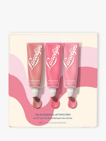 Product shot of the Lanolips The #1 Essentials Lip Tints Trio packaging on beige background. The set contains our three best-selling shades: Perfect Nude, Rhubarb and Rose. 
