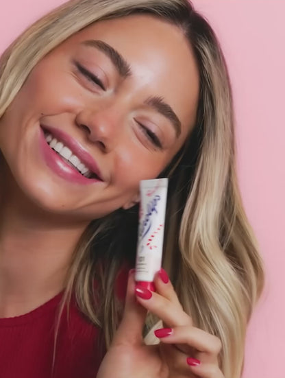 Video of model using the Lanolips 101 Ointment Multi-Balm Candy Cane, a limited edition festive gourmand flavor. 