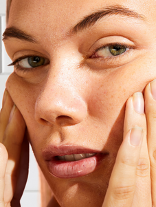 Model applying Face Base Vitamin-E Day Cream onto face