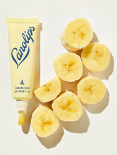 Banana Balm & Lemonaid Lip Treatment Duo | Load image into Gallery viewer, Lifestyle shot of Lanolips Banana Balm Lip Sheen 3-in-1 with cut up bananas
