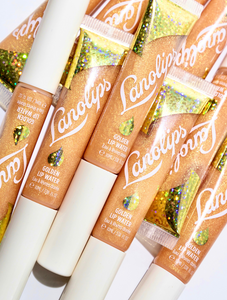 Lanolips Lip Water Liquid Gold has a hint of peppermint oil to refresh. The splash of sparkle adds instant twinkle & light. Wear alone or layer it on top of your lipstick or liner.