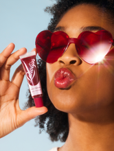 Lanolips' Glossy Balm Berry squeezed | Load image into Gallery viewer, Model wearing Glossy Balm Berry and featuring the product
