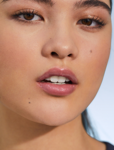 Model with Tinted Lip Balm in Rose, a creamy rose-tea sheen.