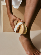 Lanolips' Dry Body Brush | Load image into Gallery viewer, Lanolips Dry Body Brush. Use light pressure in areas where your skin is thin and harder pressure on thicker skin, like the soles of your feet.
