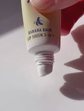 Banana Balm Sheen 3-in-1 | Load and play video in Gallery viewer, Video of Lanolips Banana Balm Lip Sheen 3-in-1 being squeezed from the tube
